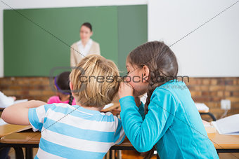Pupils whispering secrets during class