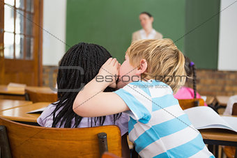Pupils whispering secrets during class