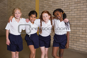 Cute pupils smiling at camera in PE uniform