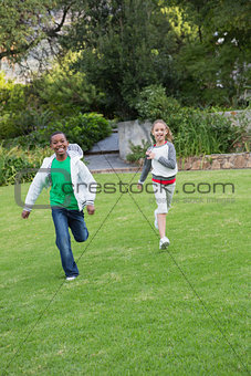 Happy young friends running towards the camera
