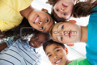 Cute schoolchildren smiling at camera from above