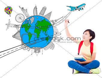 happy young woman drawing a travel trip planning