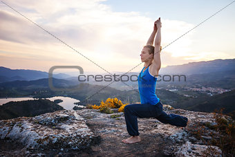 Young Caucasian woman working out on a rock