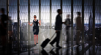 Composite image of redhead businesswoman in a blindfold