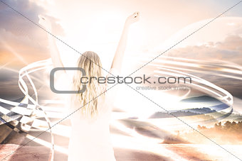 Composite image of pretty football fan in white cheering
