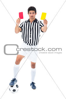 Serious referee showing red and yellow card