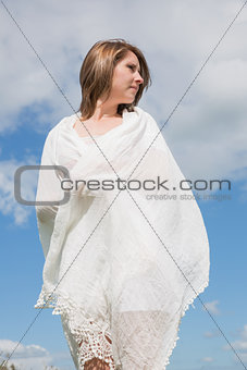 Woman looking away against blue sky and clouds