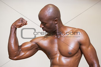 Shirtless muscular man flexing muscles