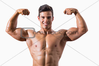Portrait of a muscular young man flexing muscles