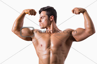 Portrait of a muscular young man flexing muscles