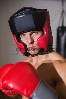 Male boxer in defensive stance in health club