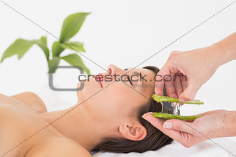 Attractive woman receiving aloe vera massage at spa center