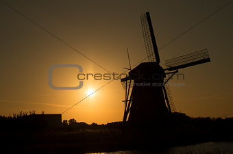 Siluet of dutch windmill (Kinderdijk) in sunset