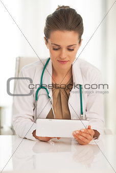 Doctor woman using tablet pc in office