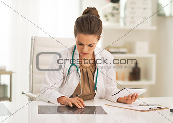 Doctor woman working with fluorography in office