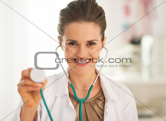 Smiling doctor woman using stethoscope
