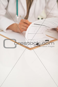 Closeup on doctor woman working in office