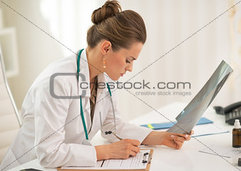 Doctor woman with fluorography working in office