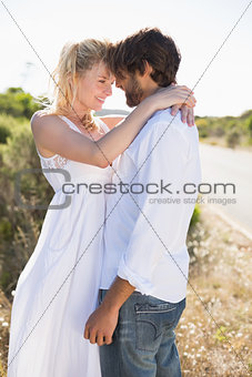 Attractive couple embracing by the road