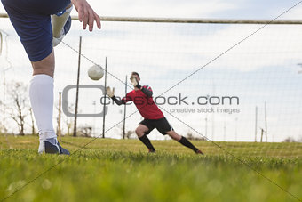 Goalkeeper in red saving a penalty