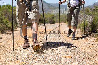 Hiking couple walking on mountain trail