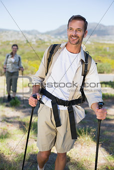 Happy hiking couple walking on mountain trail