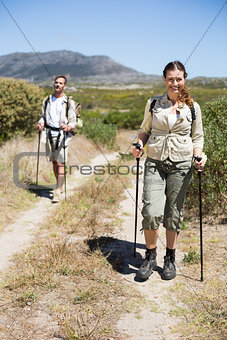 Happy hiking couple walking on country trail