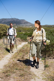 Happy hiking couple walking on country trail