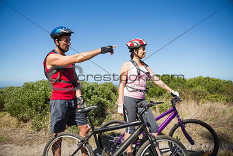 Active couple cycling in the countryside looking ahead