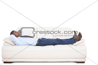 Businessman lying asleep on couch