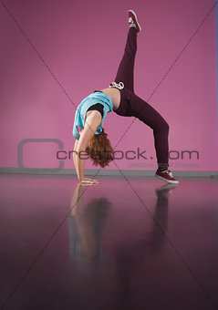 Pretty break dancer bending backwards with leg up