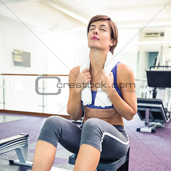 Fit brunette working out on rowing machine