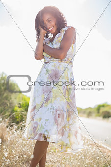 Beautiful woman in floral dress smiling at camera