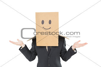 Businessman shrugging with box on head