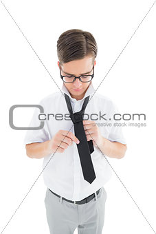 Geeky hipster fixing his tie