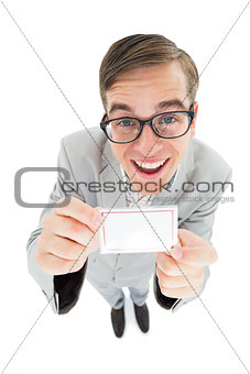 Geeky hipster smiling and showing card