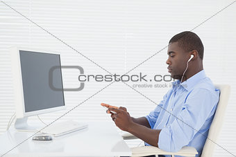 Businessman listening to music while he works