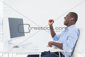 Businessman listening to music while he works