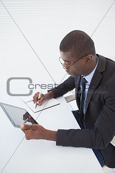 Serious businessman working with his tablet