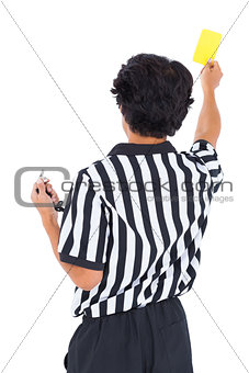 Stern referee showing yellow card