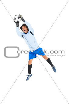 Goalkeeper in blue saving ball