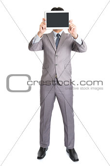 Asian businessman using computer tablet covering his face