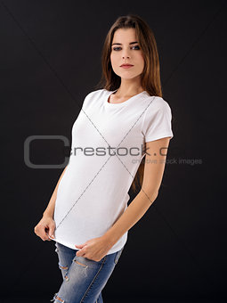 Woman with blank white shirt over black background