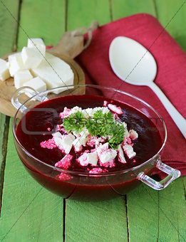 vegetable cream soup of beetroot with soft goat cheese
