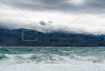 Sky with clouds and stormy waves in the sea