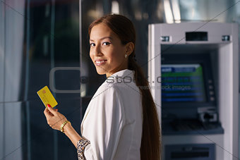 Portrait business woman withdraw cash machine card