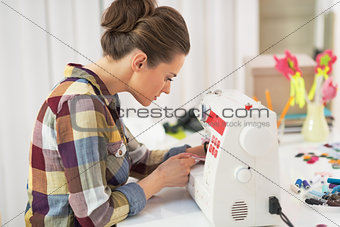 Tailor woman working with sewing machine