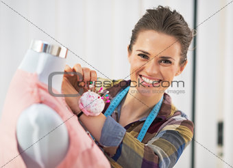 Portrait of smiling tailor woman working in studio