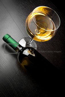 top of view of white wine glass near bottle