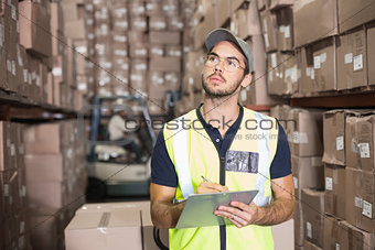 Warehouse worker checking his list
